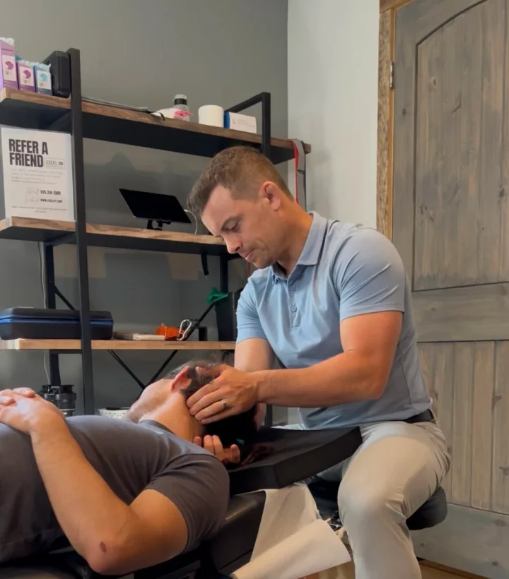 Dr. Ethan focused on a patient during a hands-on therapy session